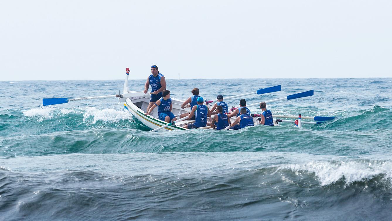 A photo of a rowing team on rough water