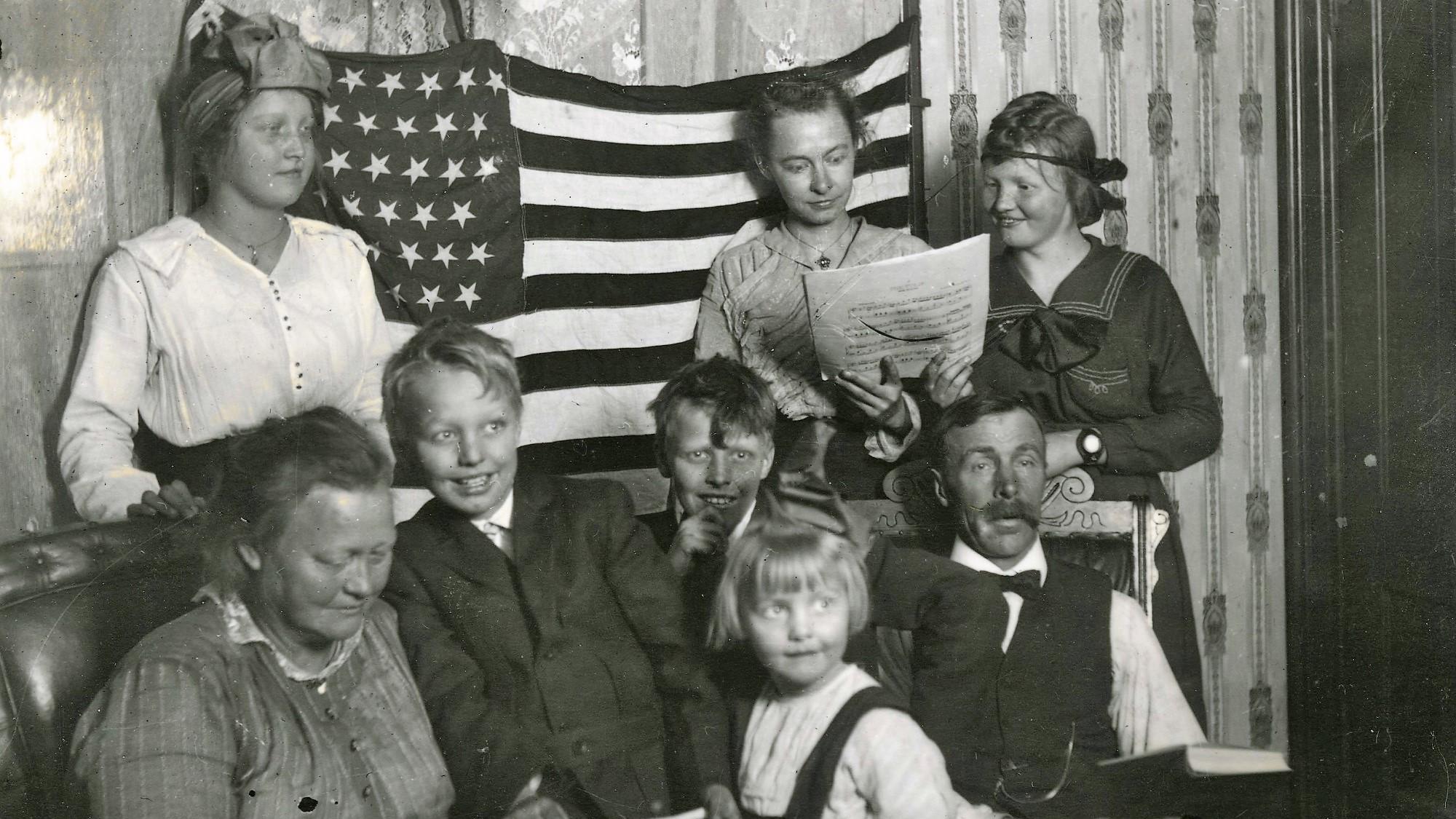 Swenson family members in front of an American flag