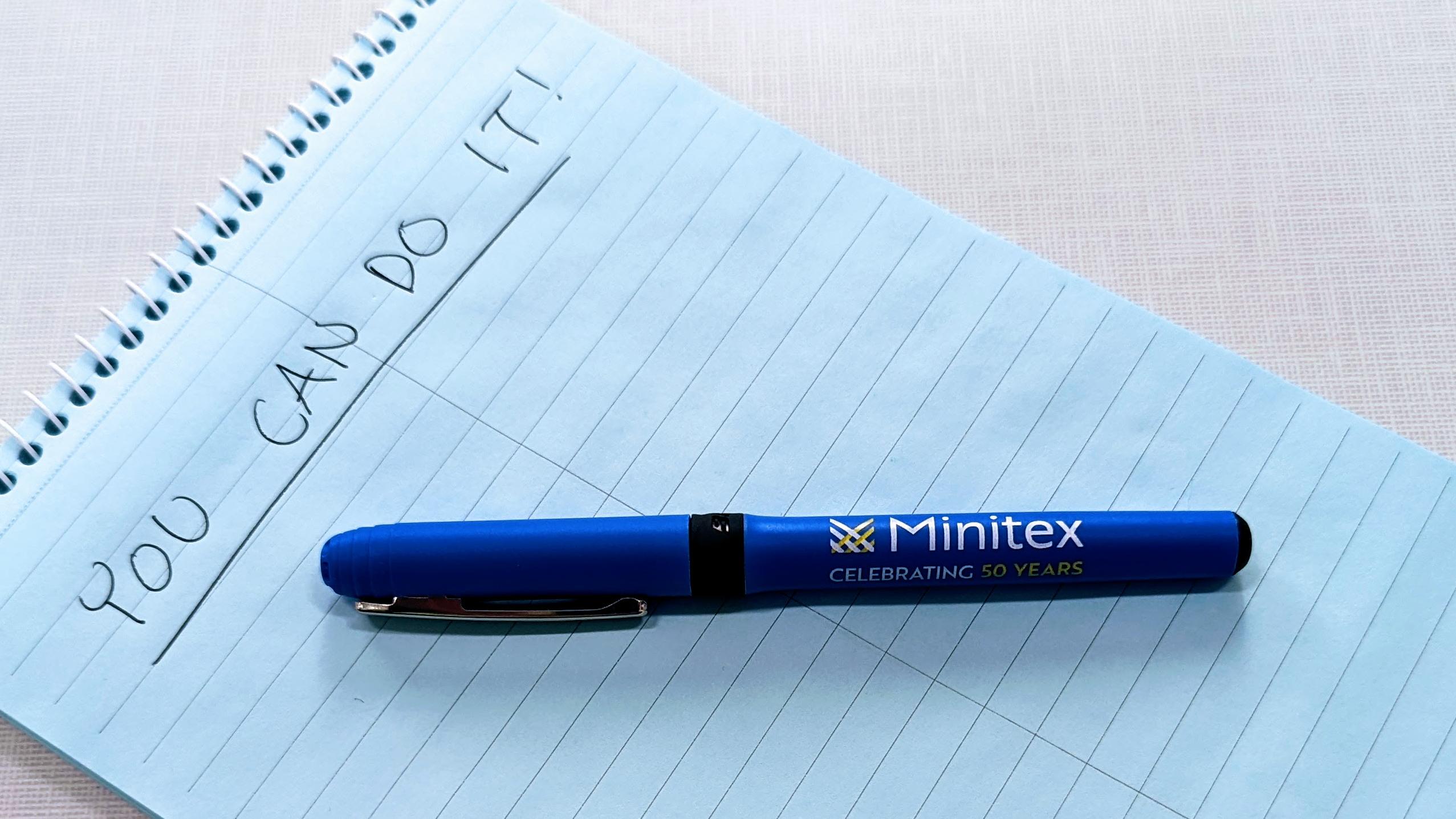 An image of a blue Minitex pen sitting on a notepad with "You can do it!" written at the top.