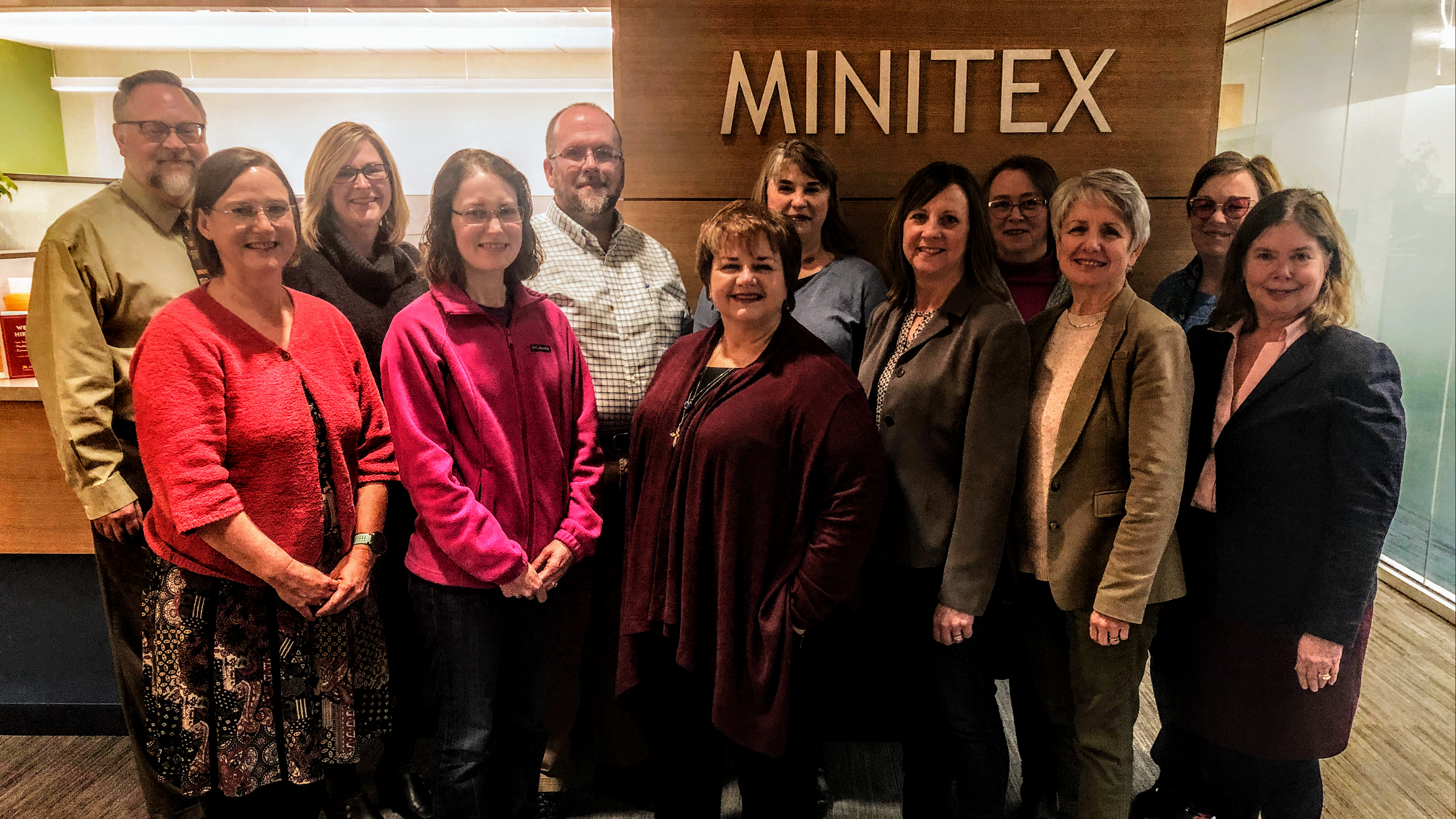 A photograph of Minitex Policy Advisory Council members taken in the front lobby of the Minitex offices.