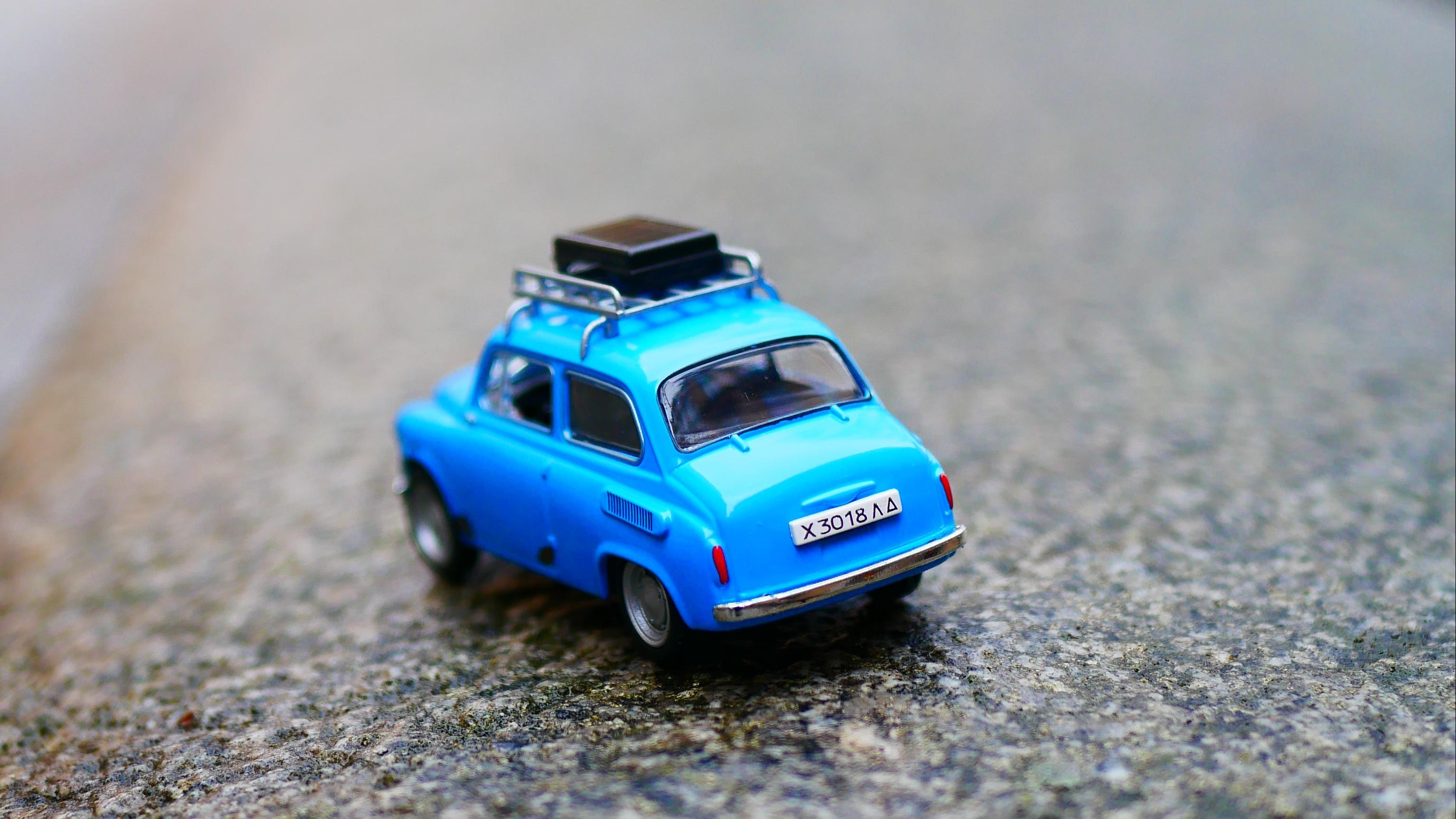 Blue toy car on road with blurred background