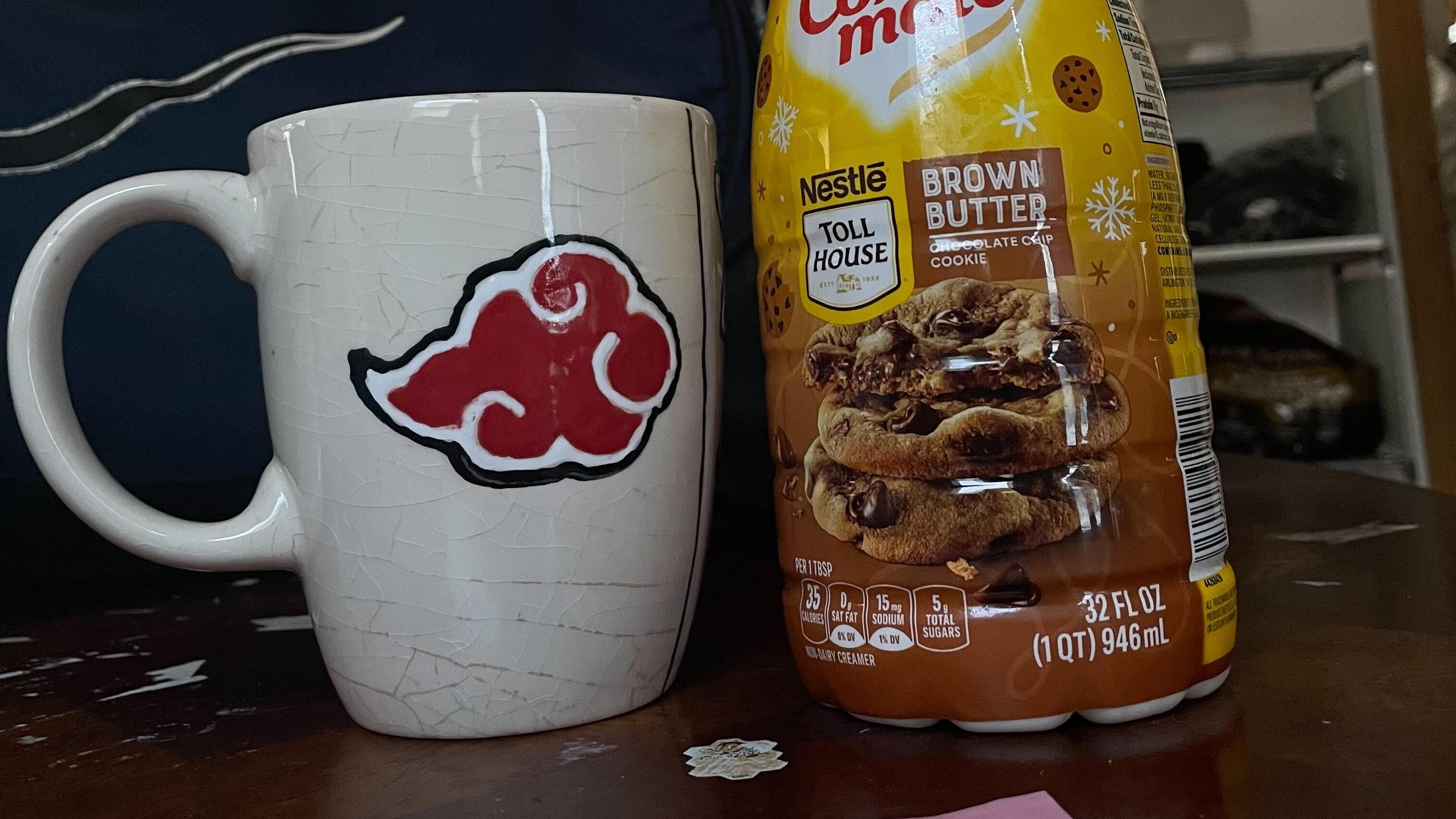 A photo of a coffee mug alongside a "Brown Butter" Nestle Coffee Mate creamer. 