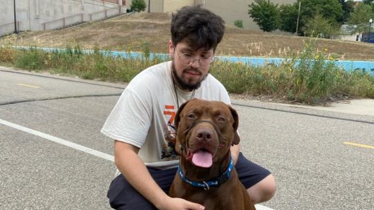 A photo of Jesus Maldonado Sanchez next to his dog.