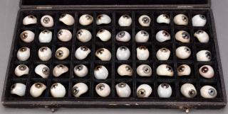Black velvet lined box  filled with fifty examples of glass eyeballs