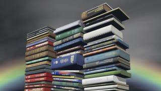 Three large stacks of books in front of a rainbow
