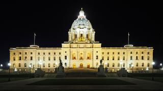 A photograph of the Minnesota State Capitol building taken at night.