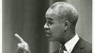 NAACP Director Roy Wilkins at a podium
