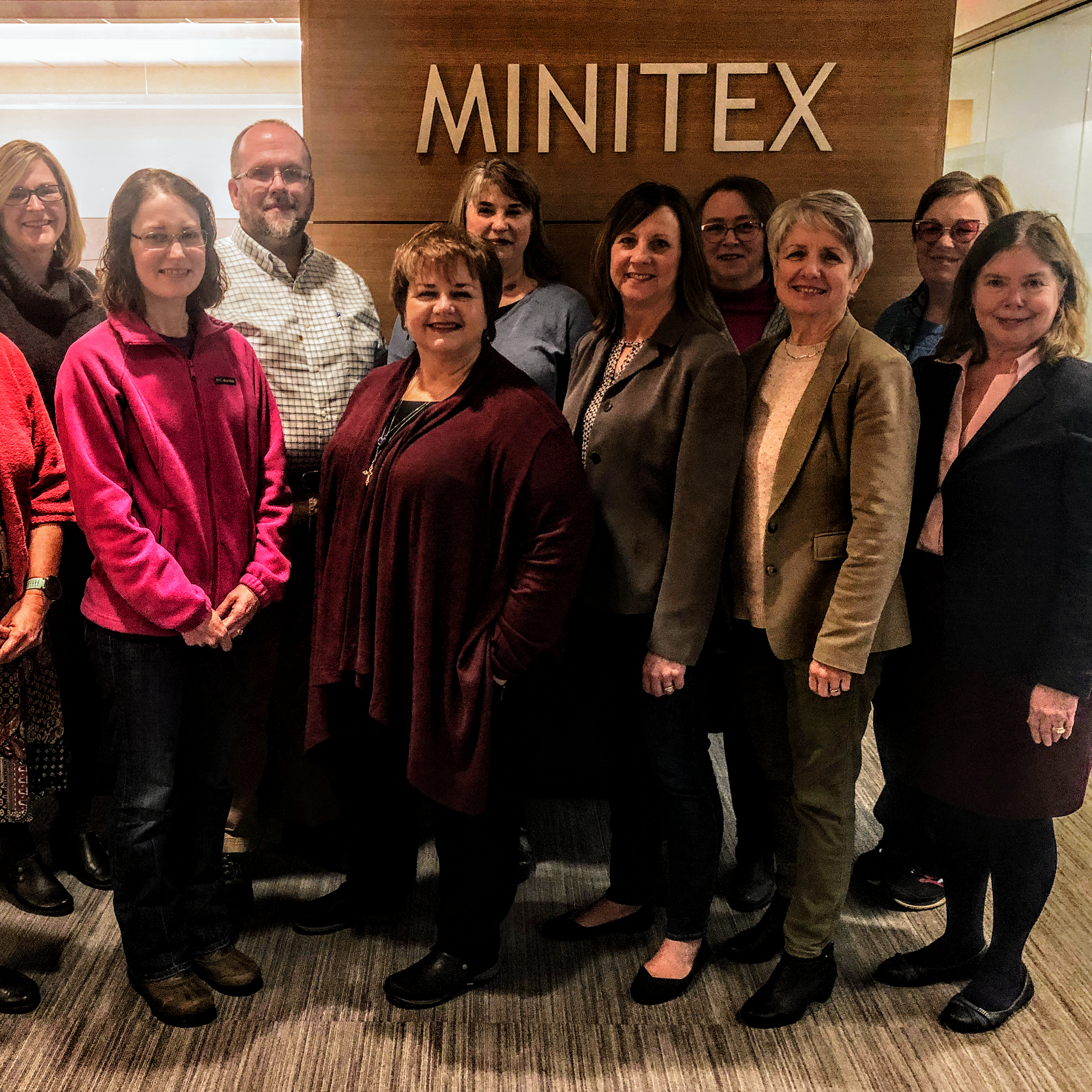 A photograph of Minitex Policy Advisory Council members taken in the front lobby of the Minitex offices.