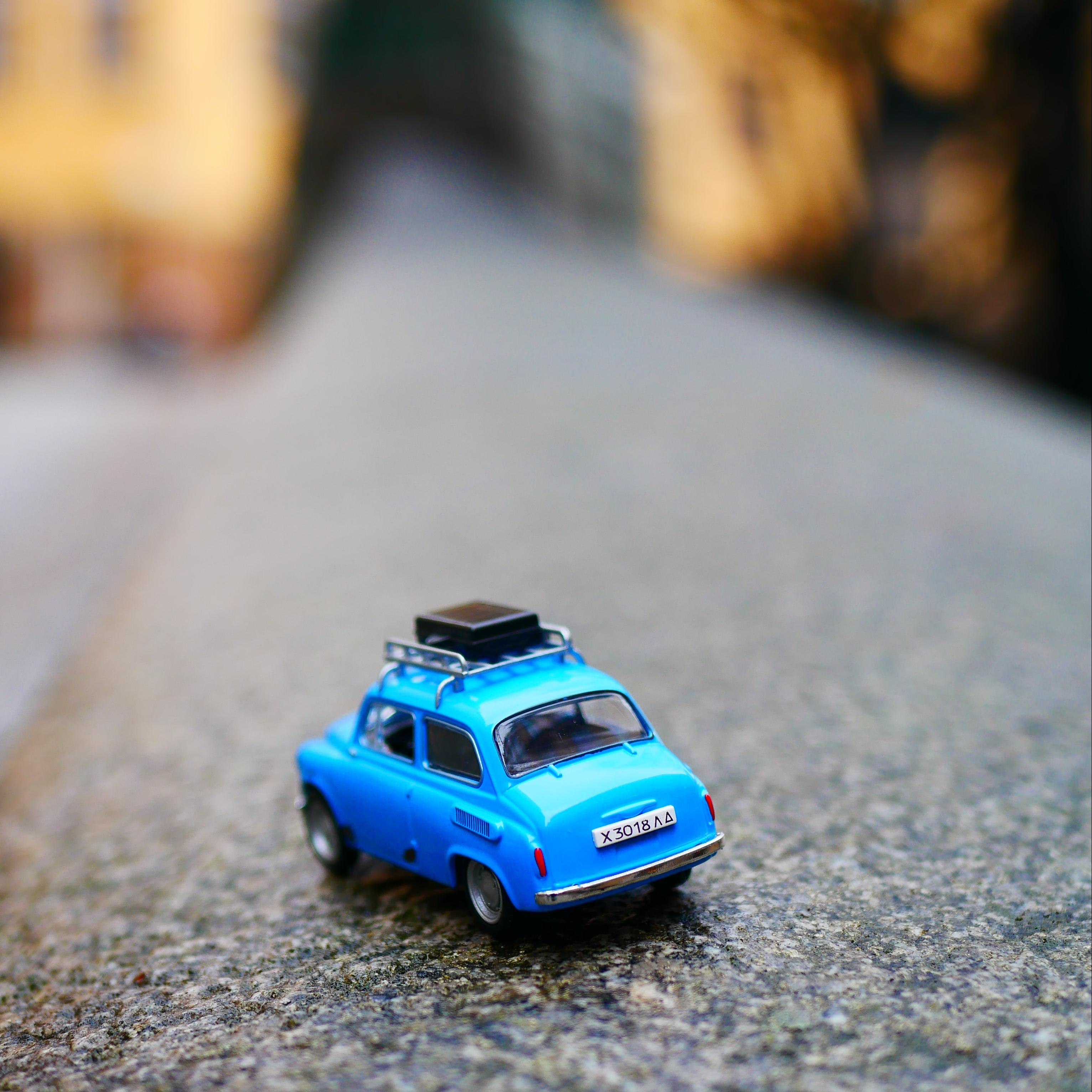 Blue toy car on road with blurred background