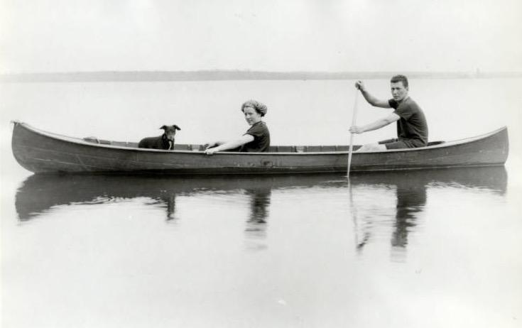 Couple in a canoe with a dog
