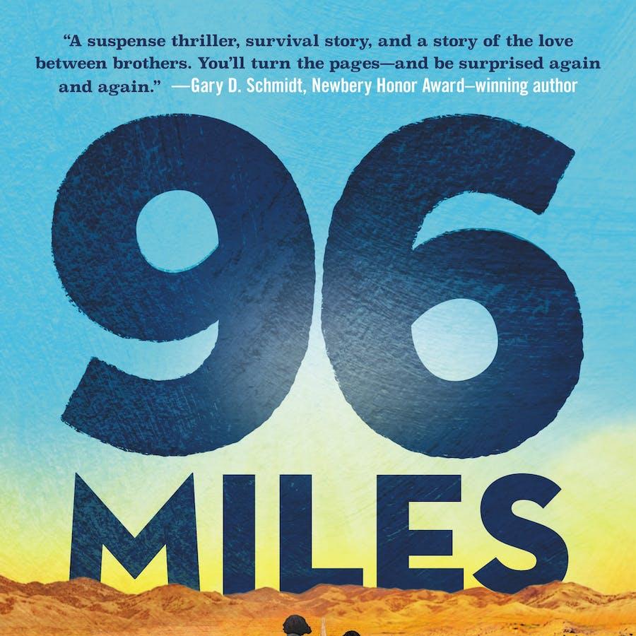 96 miles in large print with 2 boys walking down a road in the desert.