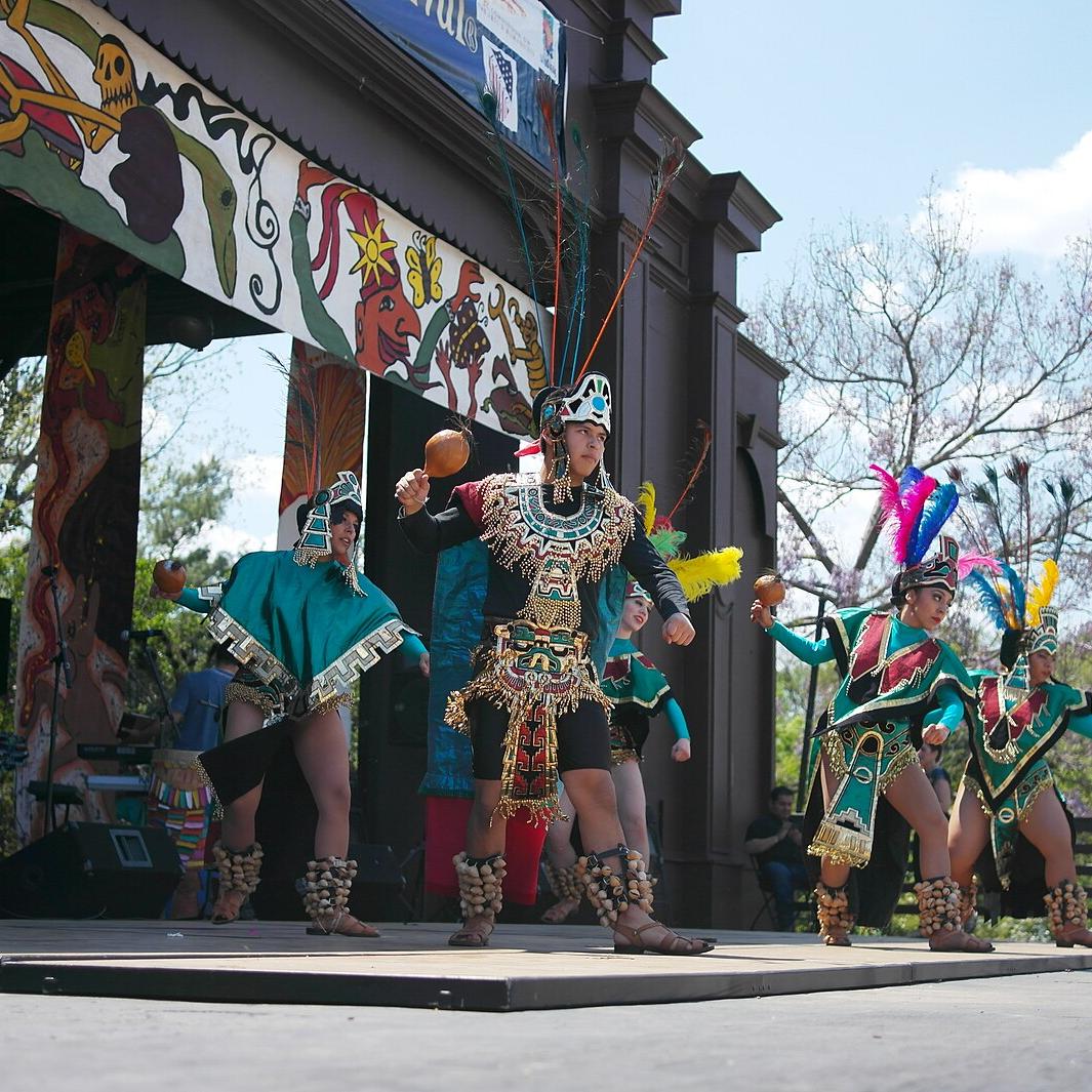 A photo of traditional Aztec dancing at a Cinco de Mayo celebration. 