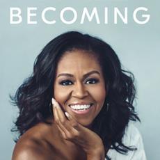 Michelle Obama resting her chin in her hand while smiling