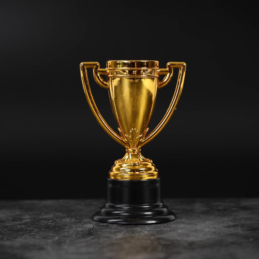 Golden trophy on a black background.
