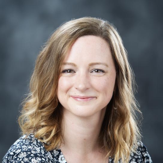 Laura Allen, shoulder length brown hair, wearing a black and white patterned shirt.